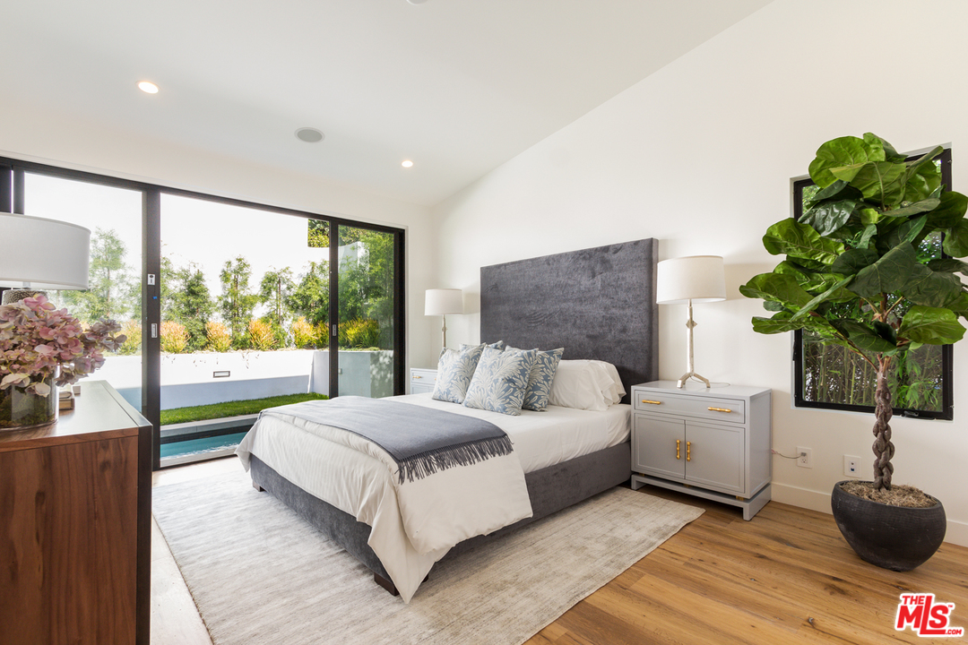 2084 Roscomare Road Los Angeles, CA 90077 - Photo 11 of 22 a living room with a bed furniture and a potted plant
