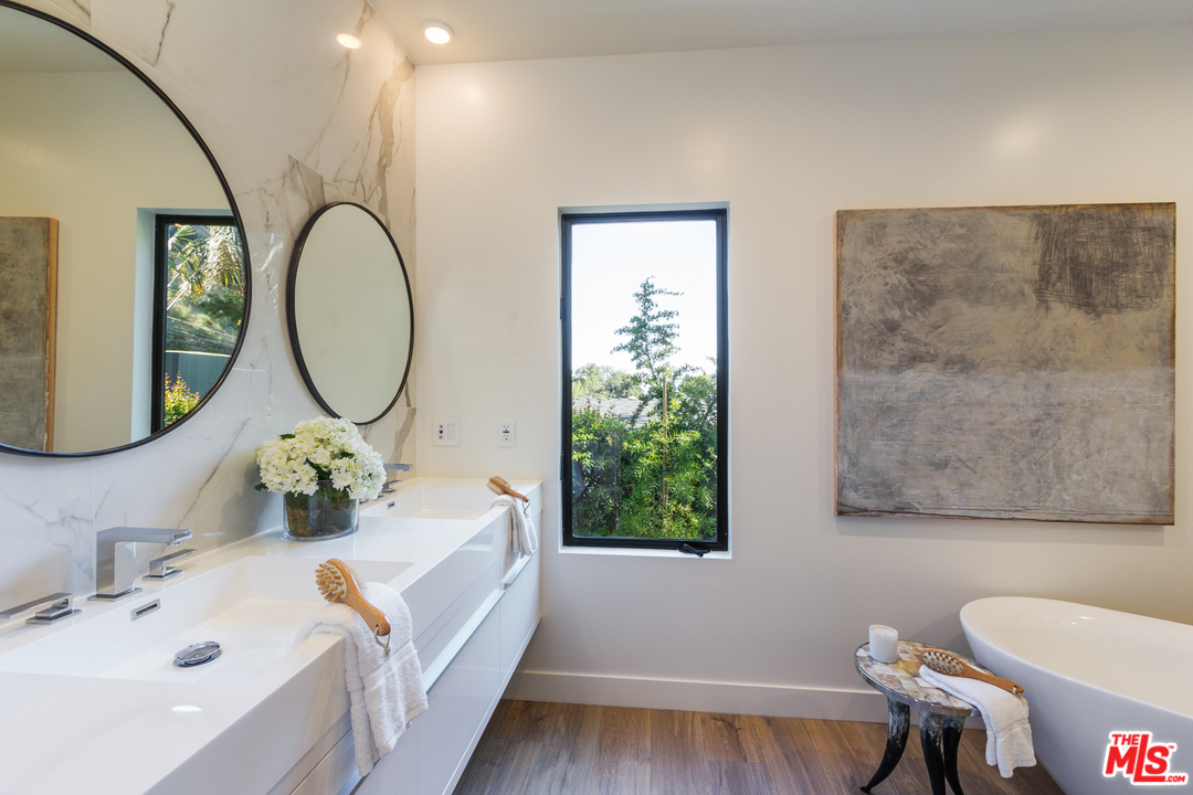 2084 Roscomare Road Los Angeles, CA 90077 - Photo 13 of 22 a bathroom with a sink and a mirror