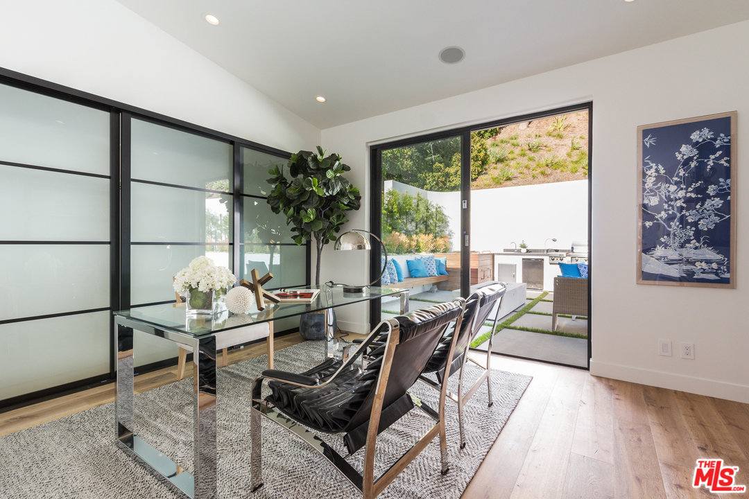 2084 Roscomare Road Los Angeles, CA 90077 - Photo 18 of 22 a dining room with furniture and a floor to ceiling window