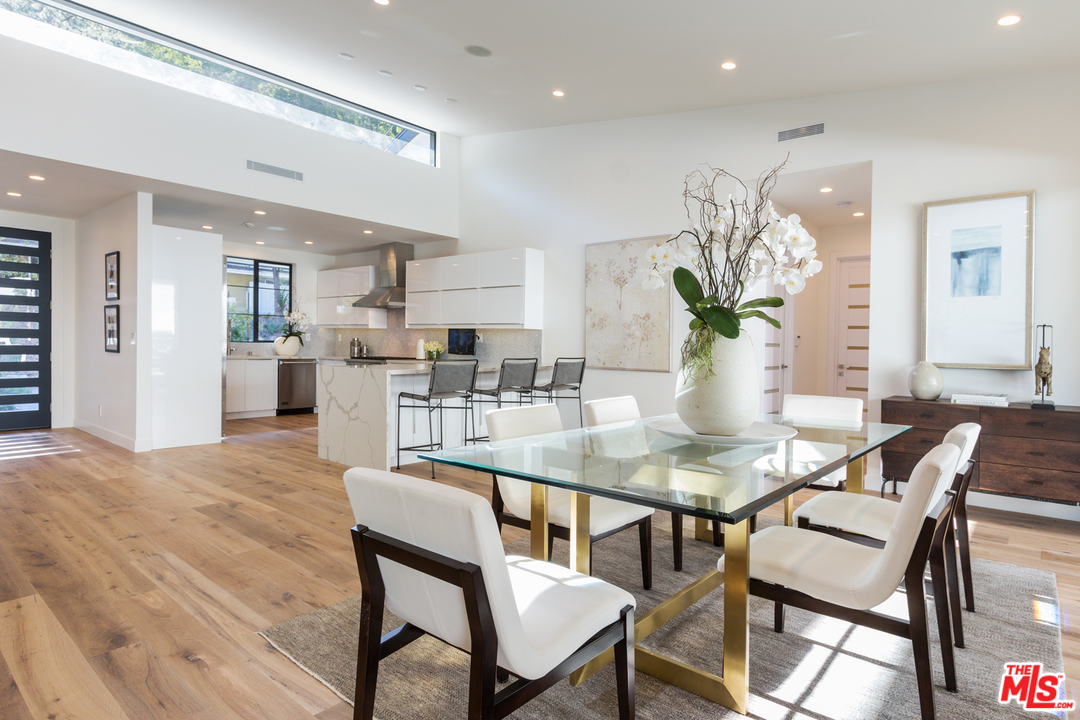 2084 Roscomare Road Los Angeles, CA 90077 - Photo 8 of 22 a dining room filled chandelier and wooden floor
