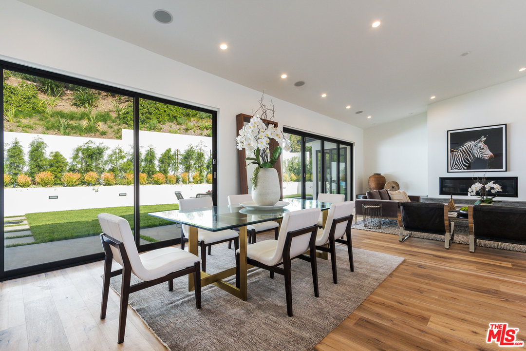 2084 Roscomare Road Los Angeles, CA 90077 - Photo 9 of 22 a view of a dining room with furniture window and wooden floor