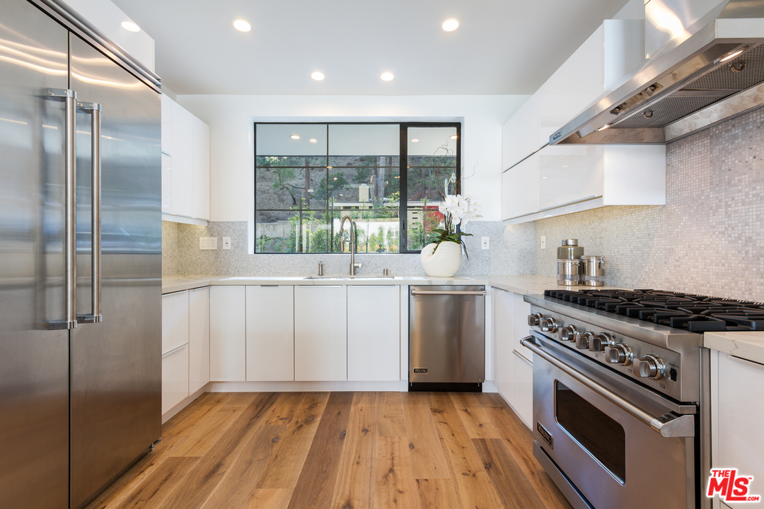 2084 Roscomare Road Los Angeles, CA 90077 - Photo 10 of 22 a kitchen with a stove a sink and a refrigerator