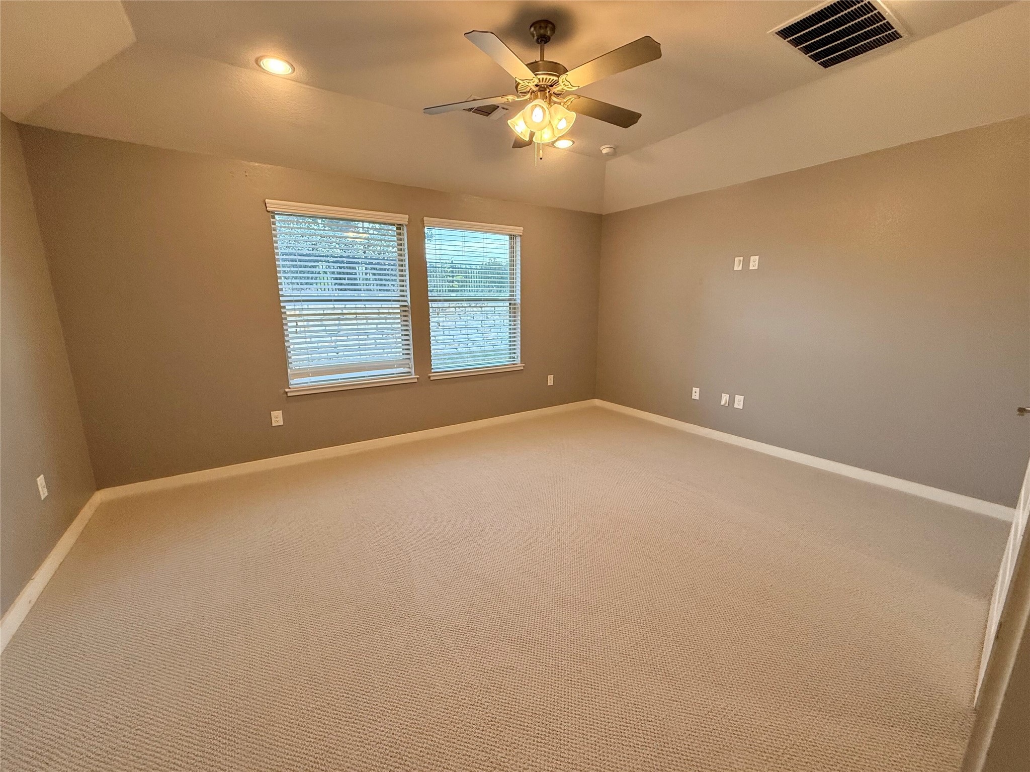 7216 Sienna Rouge Path Austin, TX 78744 - Photo 11 of 37 an empty room with windows and fan