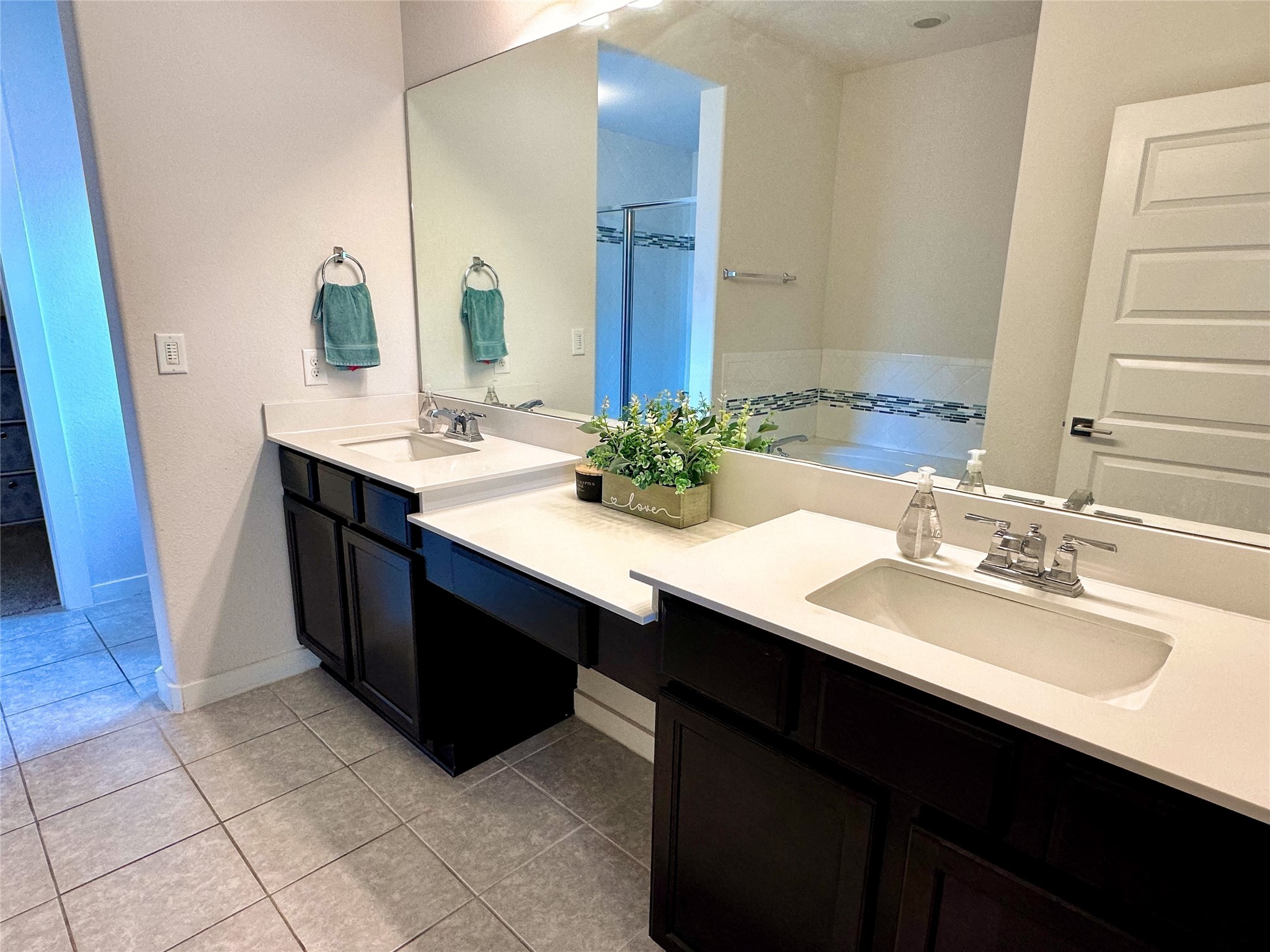 7216 Sienna Rouge Path Austin, TX 78744 - Photo 13 of 37 a bathroom with a sink double vanity and a mirror