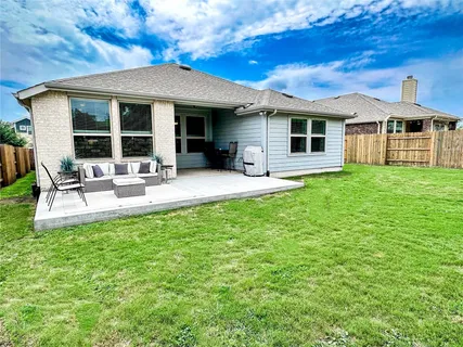 a front view of a house with a garden and sitting area