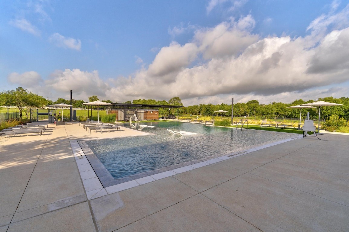7216 Sienna Rouge Path Austin, TX 78744 - Photo 29 of 37 a view of swimming pool with outdoor seating and city view