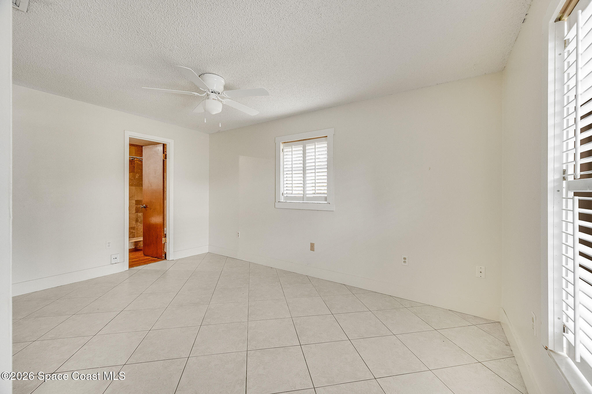 2623 Reed Avenue Melbourne, FL 32901 - Photo 24 of 45 an empty room with windows and fan
