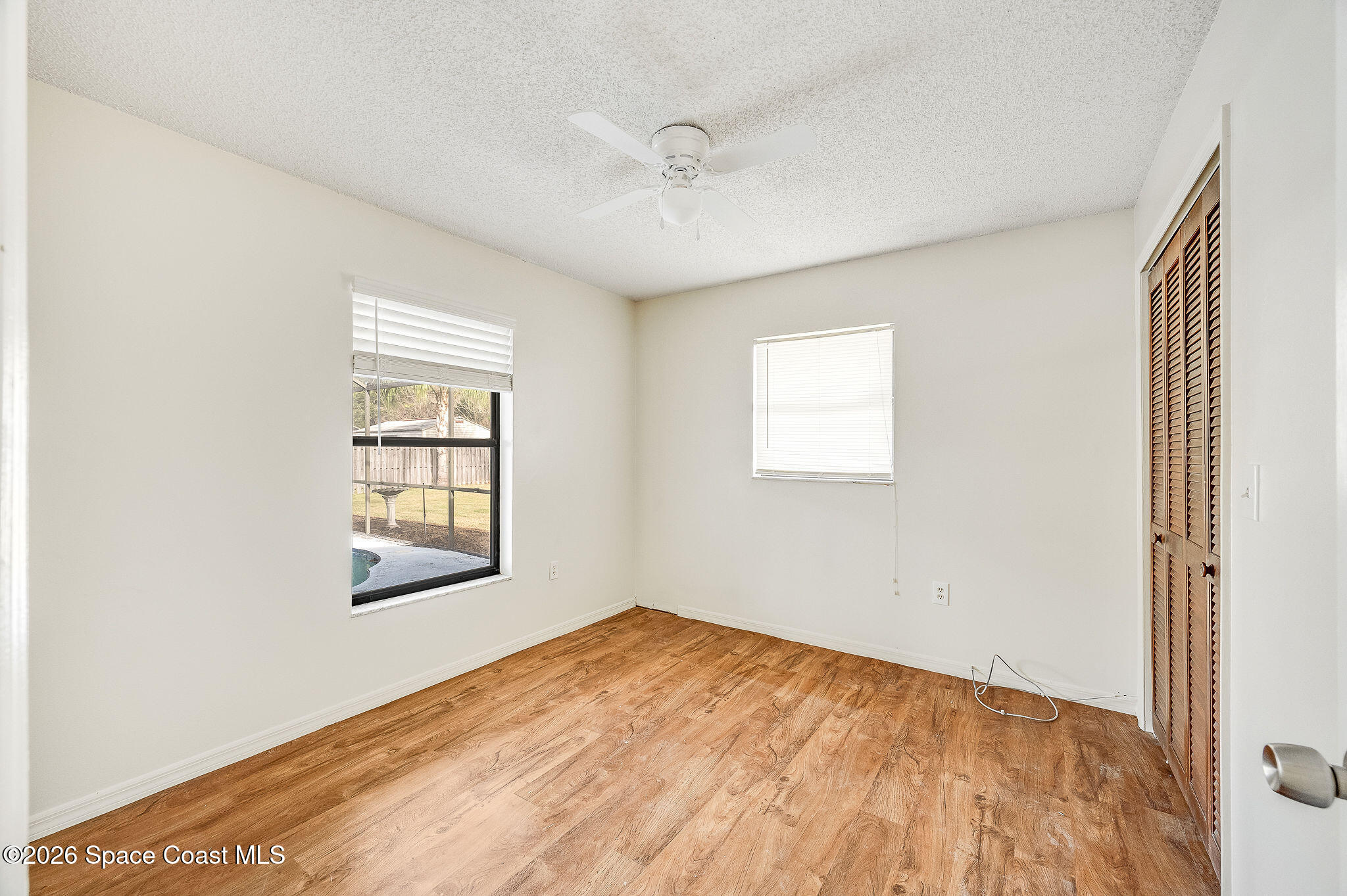 2623 Reed Avenue Melbourne, FL 32901 - Photo 29 of 45 a view of empty room with wooden floor and fan