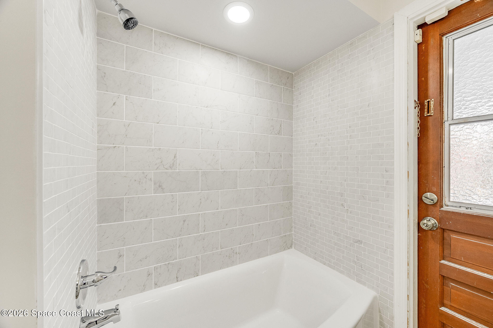 2623 Reed Avenue Melbourne, FL 32901 - Photo 30 of 45 a bath tub sitting in a bathroom next to a window