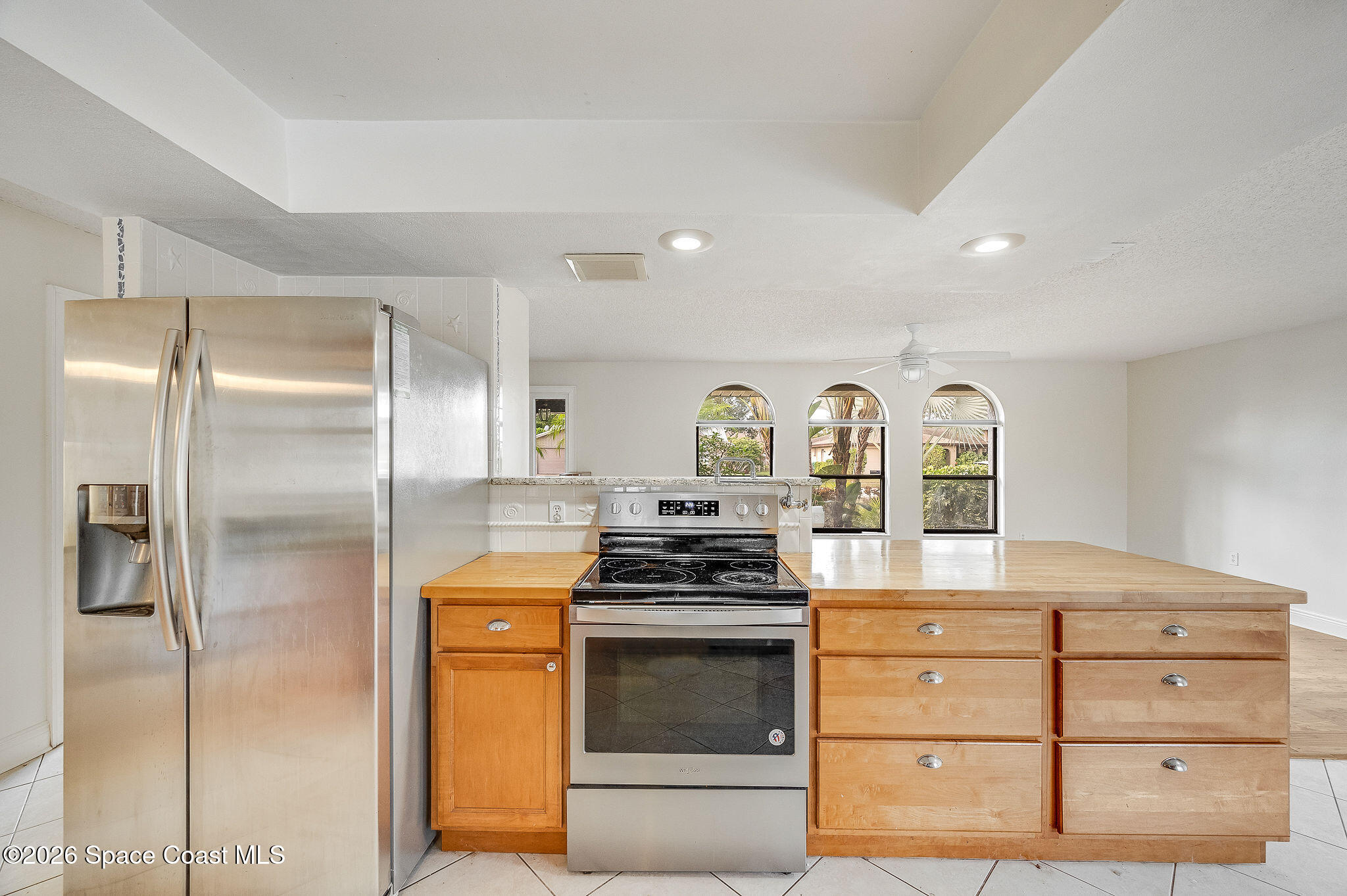 2623 Reed Avenue Melbourne, FL 32901 - Photo 37 of 45 a kitchen with stainless steel appliances granite countertop a stove a refrigerator and a stove