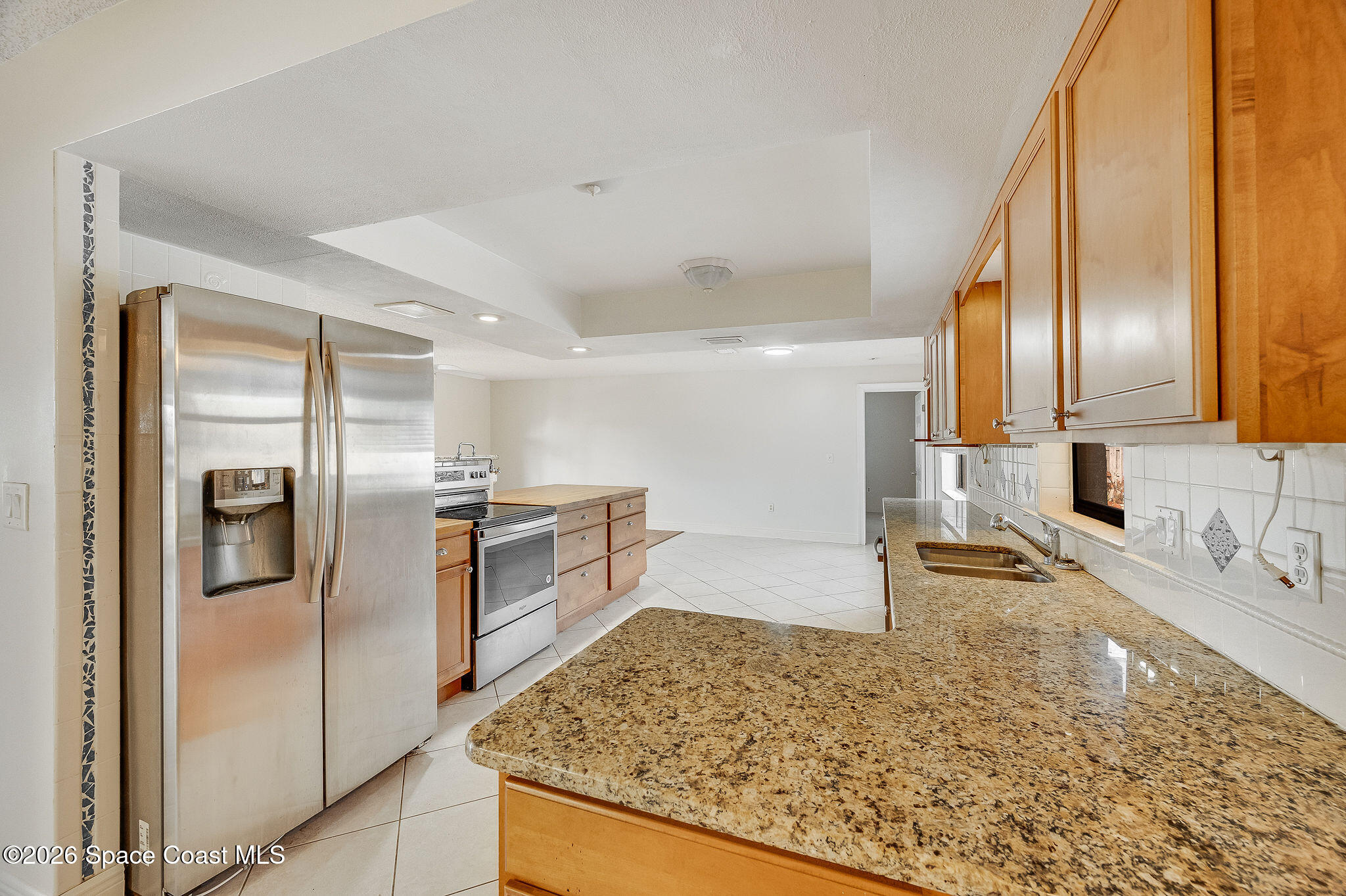 2623 Reed Avenue Melbourne, FL 32901 - Photo 40 of 45 a kitchen with stainless steel appliances granite countertop a sink stove and refrigerator