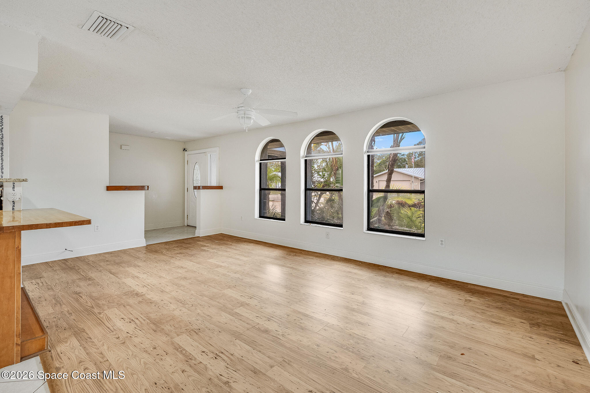 2623 Reed Avenue Melbourne, FL 32901 - Photo 9 of 45 a view of an empty room with window and wooden floor