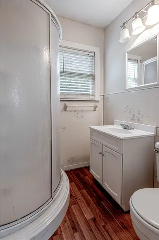 a bathroom with a sink toilet and window