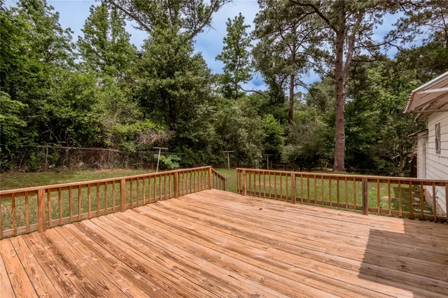 a view of balcony with wooden floor and fence