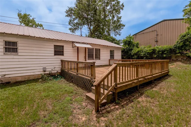 a view of a house with wooden fence