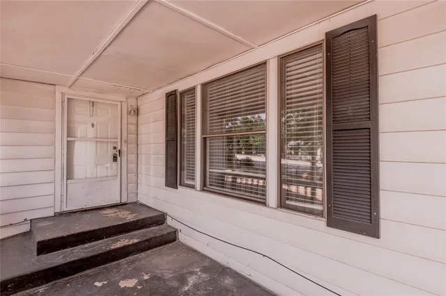 a view of wooden door and brick wall