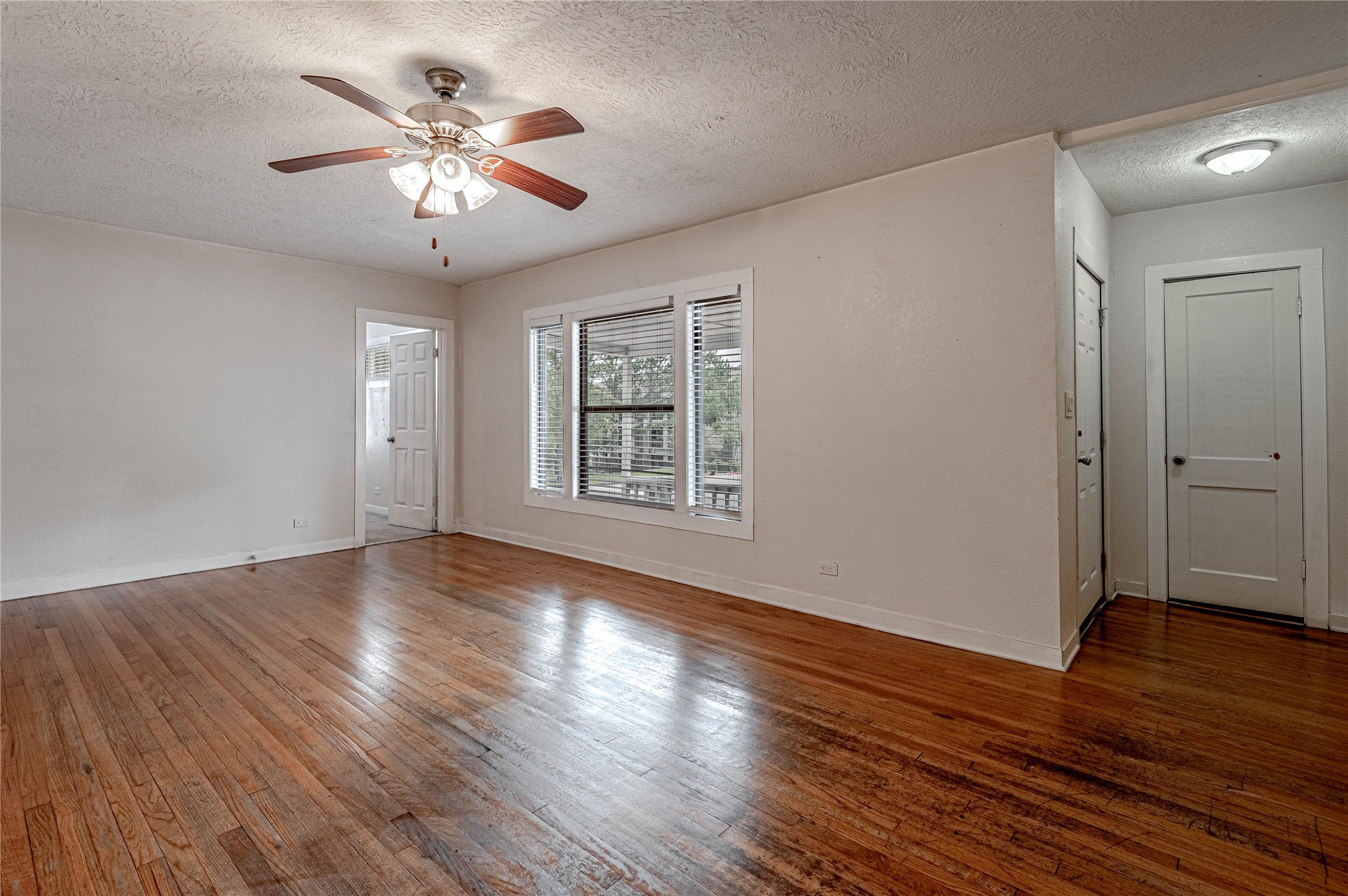 2538 Sycamore Avenue Huntsville, TX 77340 - Photo 6 of 31 a view of an empty room with wooden floor and a window