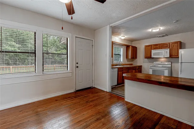 a kitchen with stainless steel appliances granite countertop a refrigerator and a stove top oven