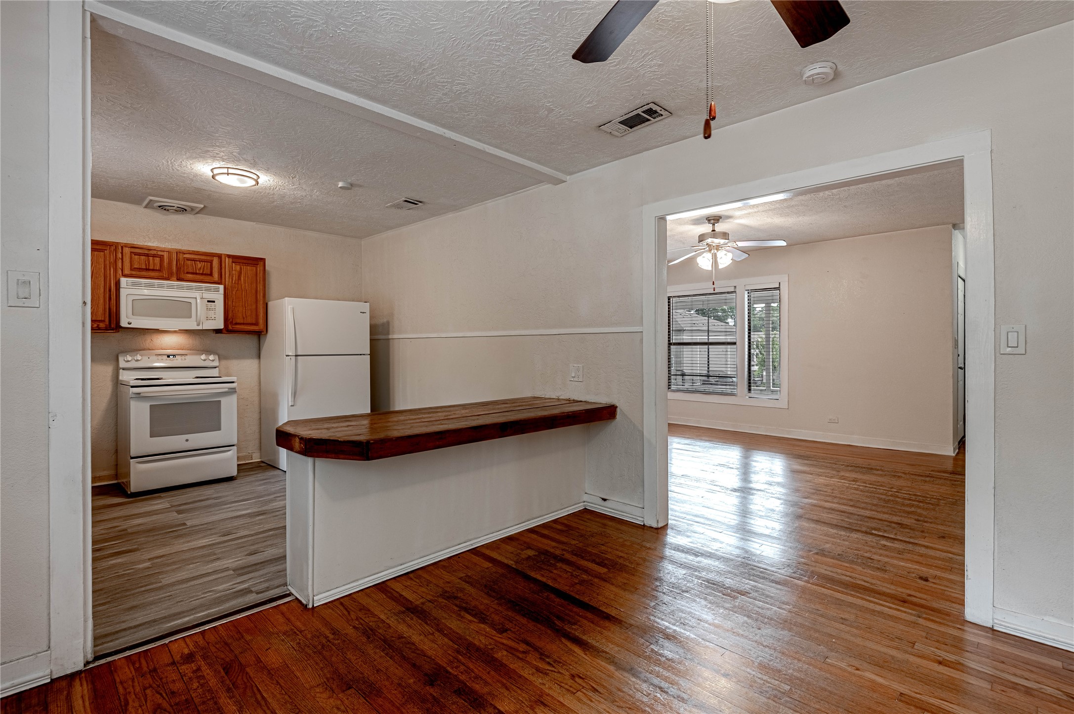 2538 Sycamore Avenue Huntsville, TX 77340 - Photo 9 of 31 a kitchen with stainless steel appliances granite countertop a refrigerator a stove and a wooden floors