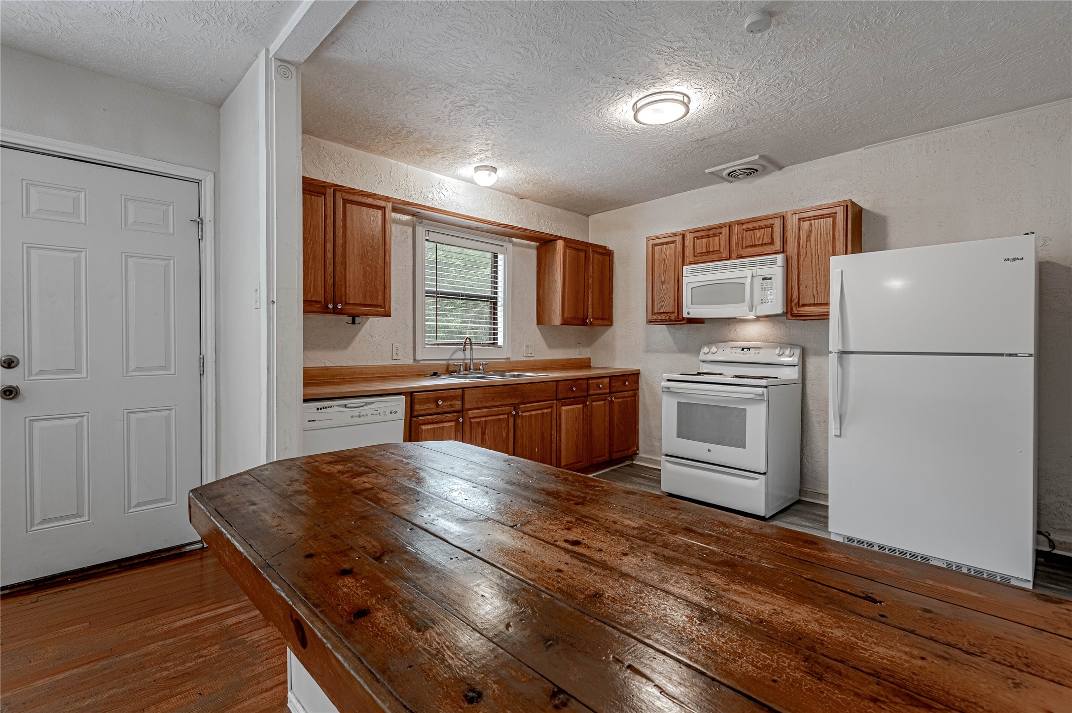 2538 Sycamore Avenue Huntsville, TX 77340 - Photo 10 of 31 a kitchen with stainless steel appliances granite countertop a refrigerator a stove and a sink with wooden floor