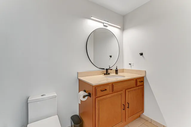 a bathroom with a toilet a sink and mirror