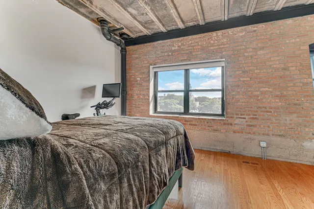 a bedroom with a bed and a window