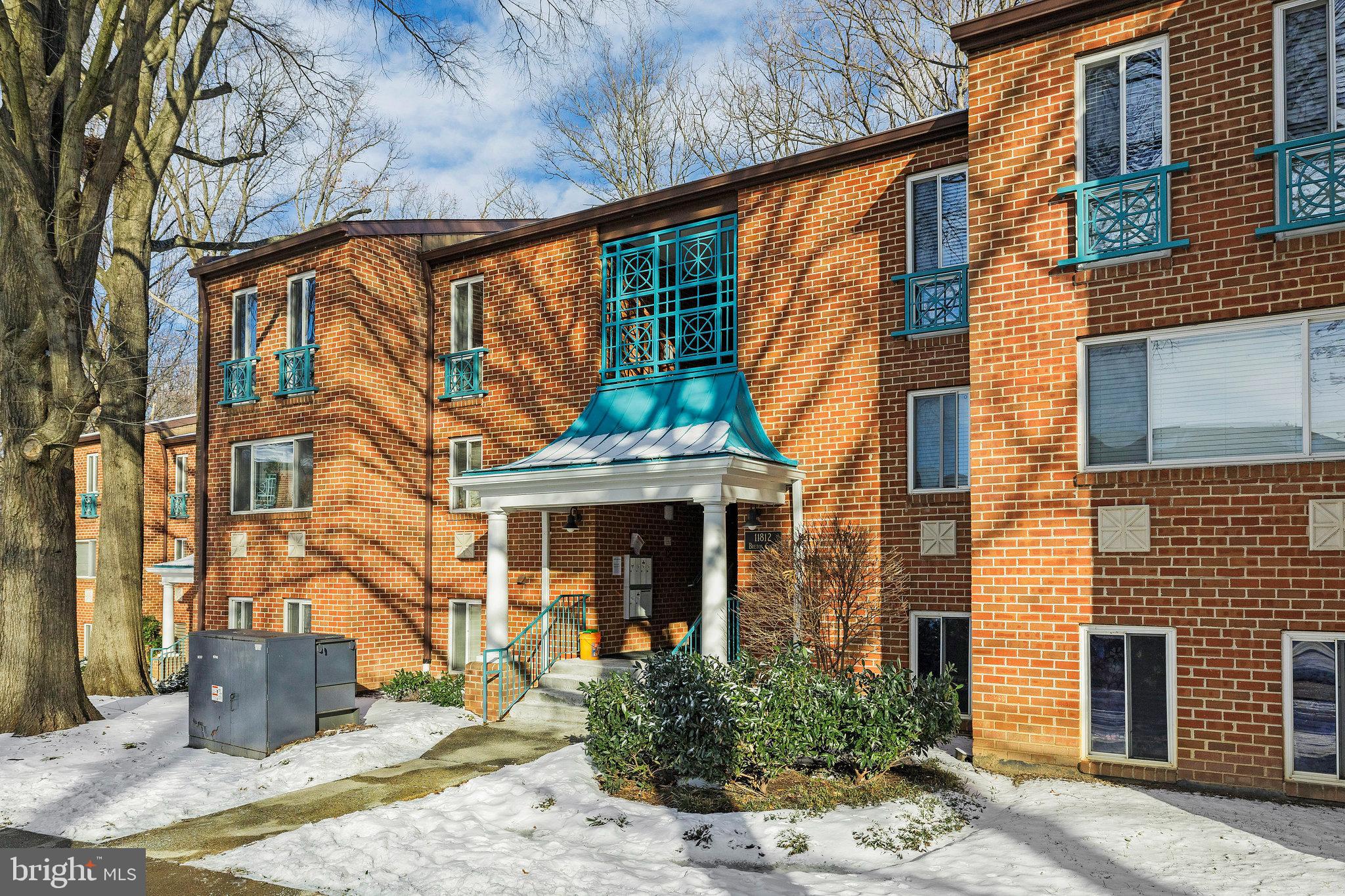 11812 Breton Court, Unit 1A Reston, VA 20191 - Photo 1 of 47 a front view of a house with a yard
