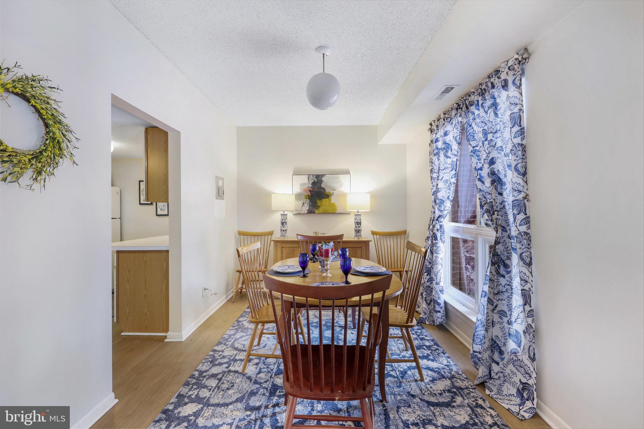 11812 Breton Court, Unit 1A Reston, VA 20191 - Photo 11 of 47 a dining room with furniture and wooden floor