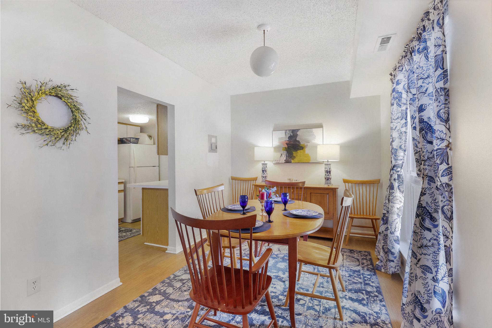 11812 Breton Court, Unit 1A Reston, VA 20191 - Photo 12 of 47 a view of a dining room with furniture and wooden floor