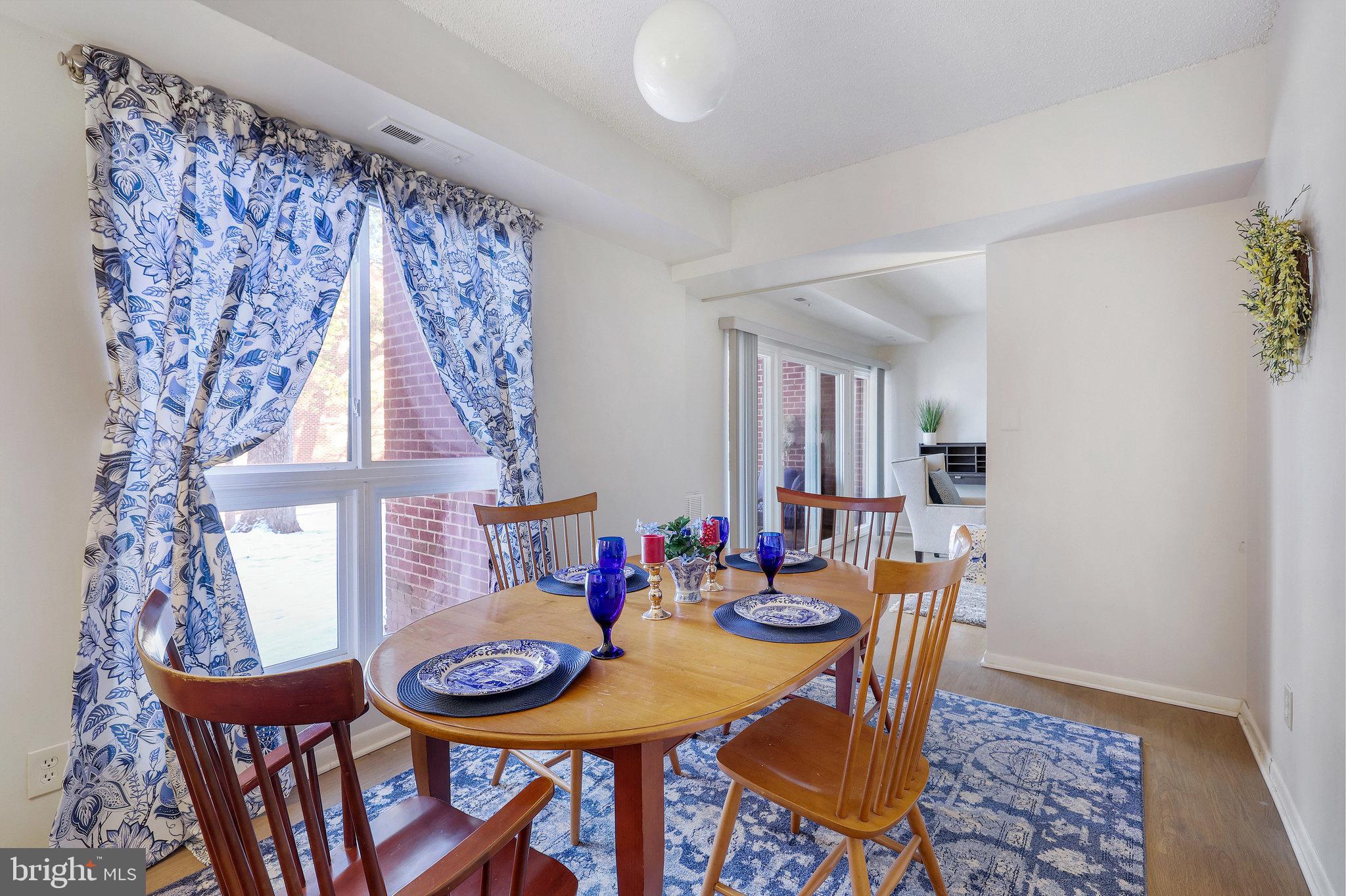 11812 Breton Court, Unit 1A Reston, VA 20191 - Photo 15 of 47 a view of a dining room with furniture and wooden floor