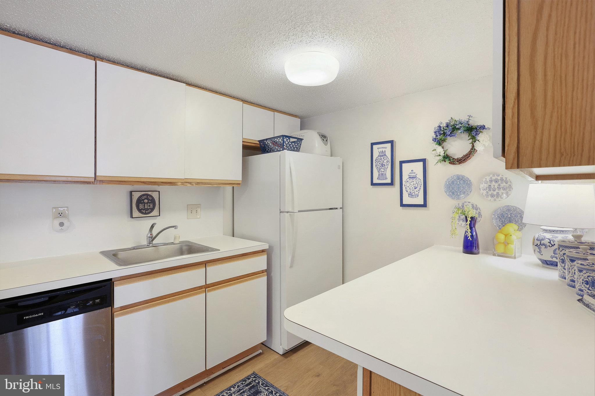 11812 Breton Court, Unit 1A Reston, VA 20191 - Photo 19 of 47 a kitchen with a sink and a refrigerator