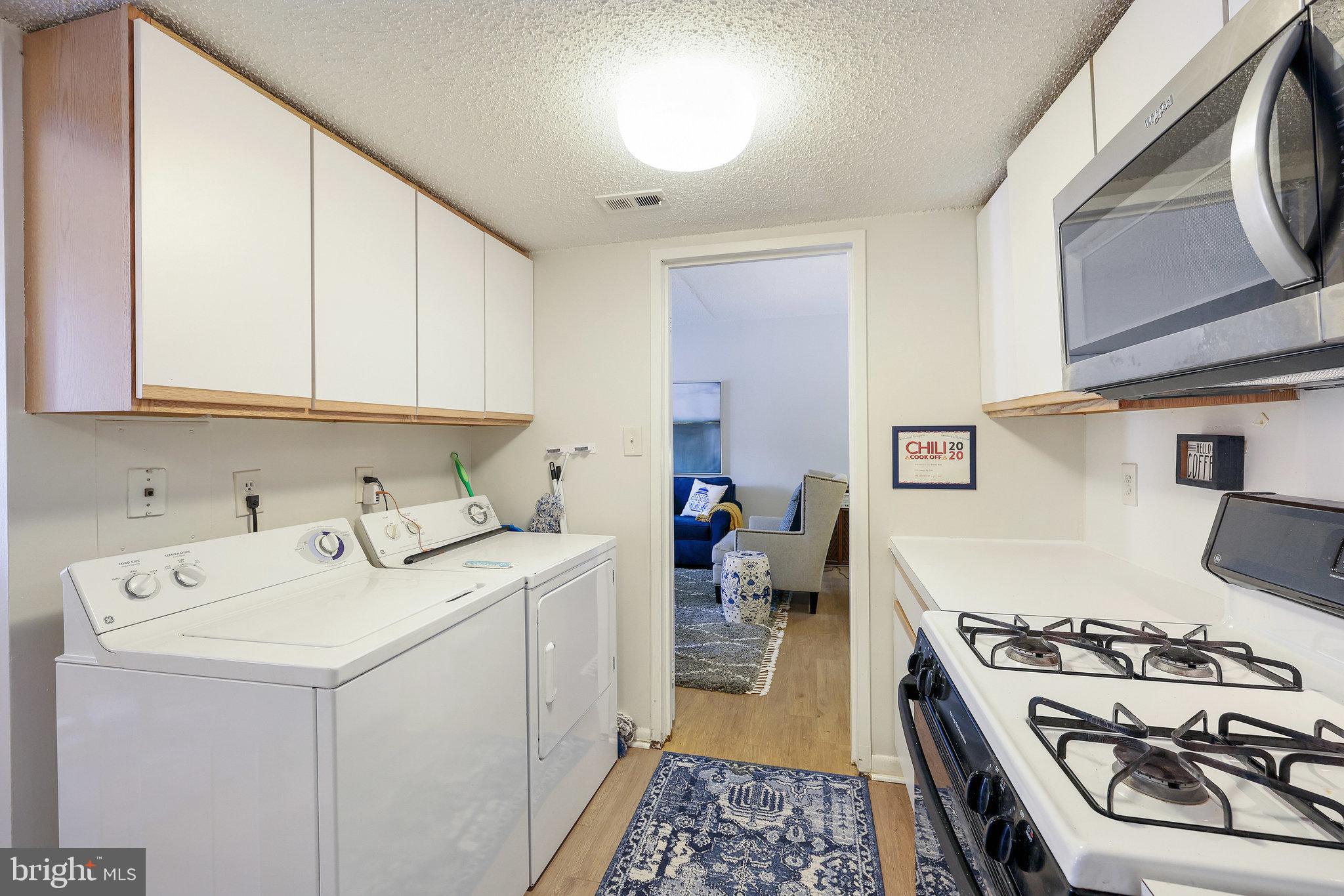 11812 Breton Court, Unit 1A Reston, VA 20191 - Photo 20 of 47 a kitchen with a sink a stove and cabinets