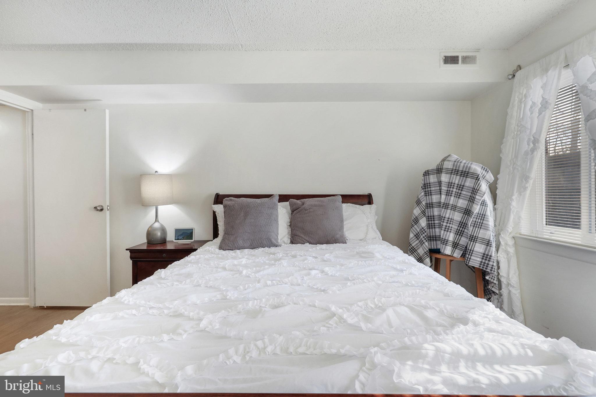 11812 Breton Court, Unit 1A Reston, VA 20191 - Photo 23 of 47 a large white bed in a white room