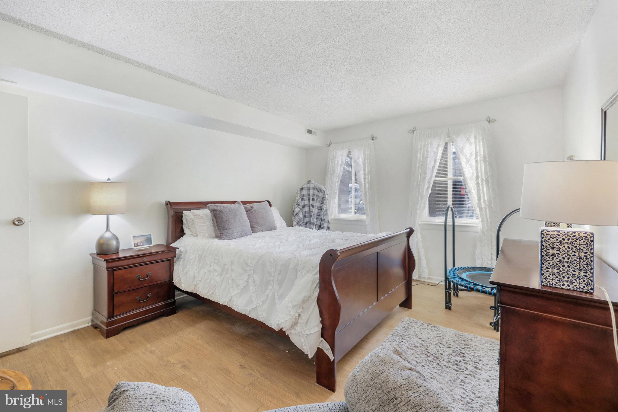 11812 Breton Court, Unit 1A Reston, VA 20191 - Photo 24 of 47 a bedroom with a bed and window