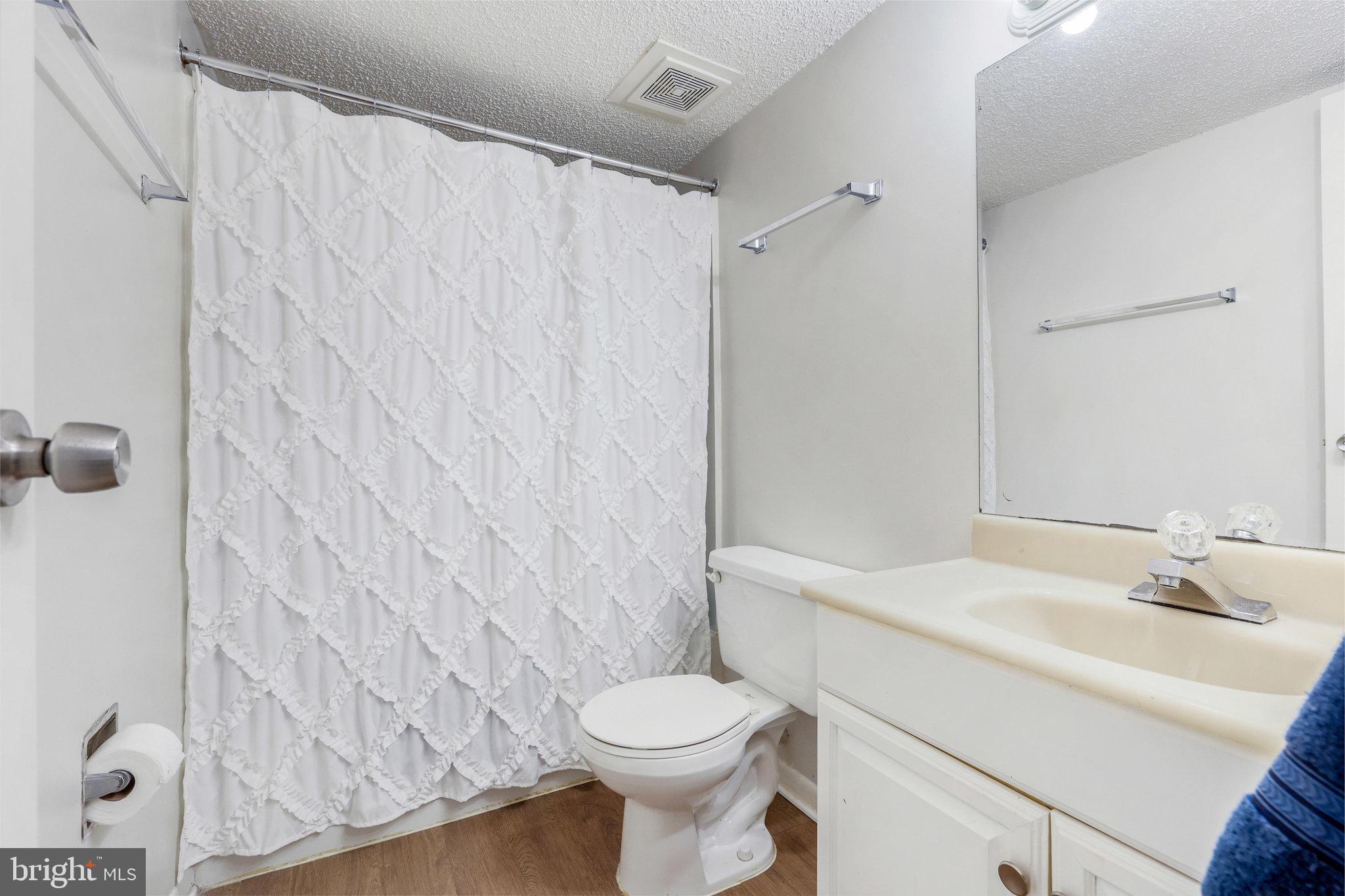11812 Breton Court, Unit 1A Reston, VA 20191 - Photo 25 of 47 a bathroom with a sink toilet and shower