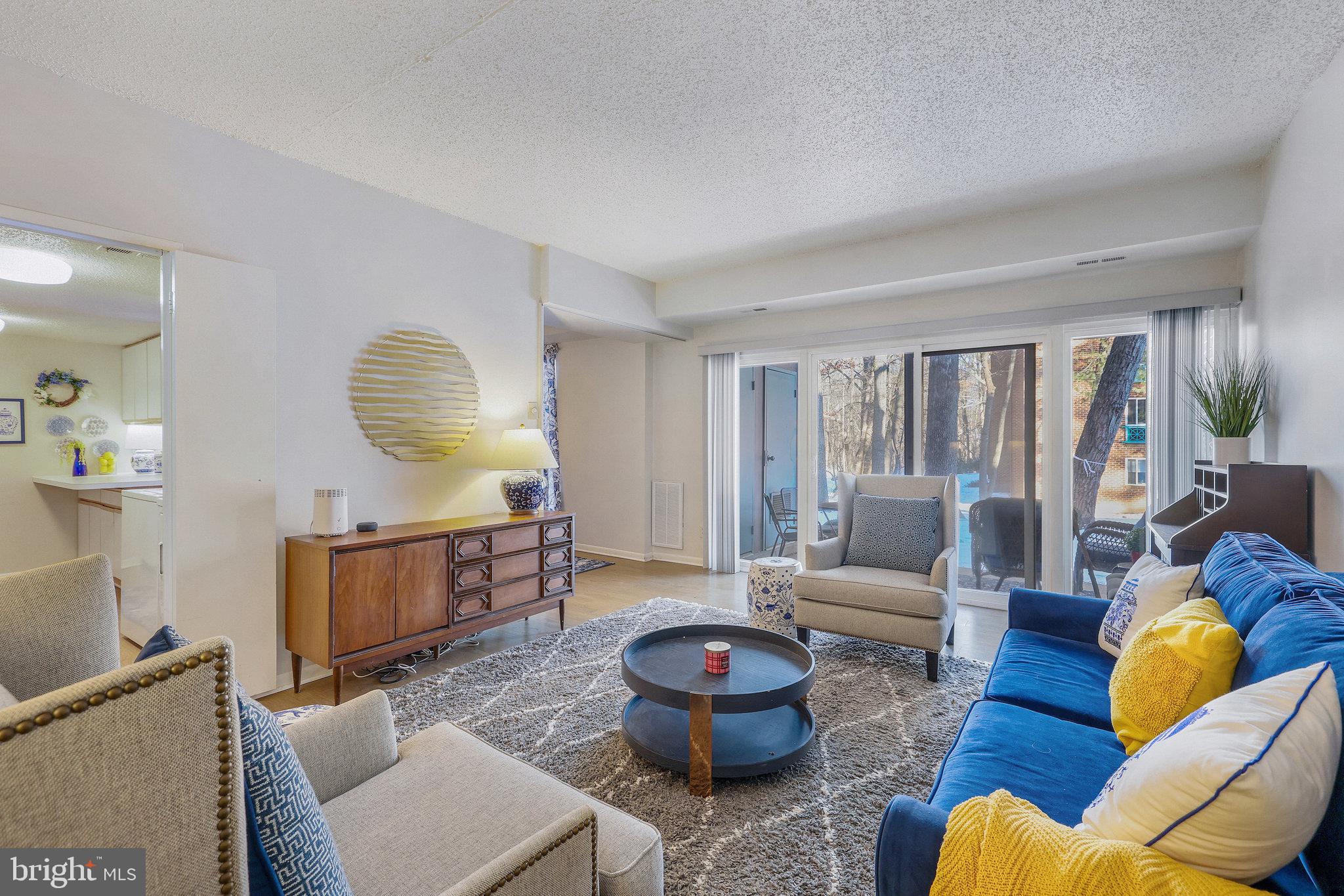 11812 Breton Court, Unit 1A Reston, VA 20191 - Photo 6 of 47 a living room with furniture and a wooden floor