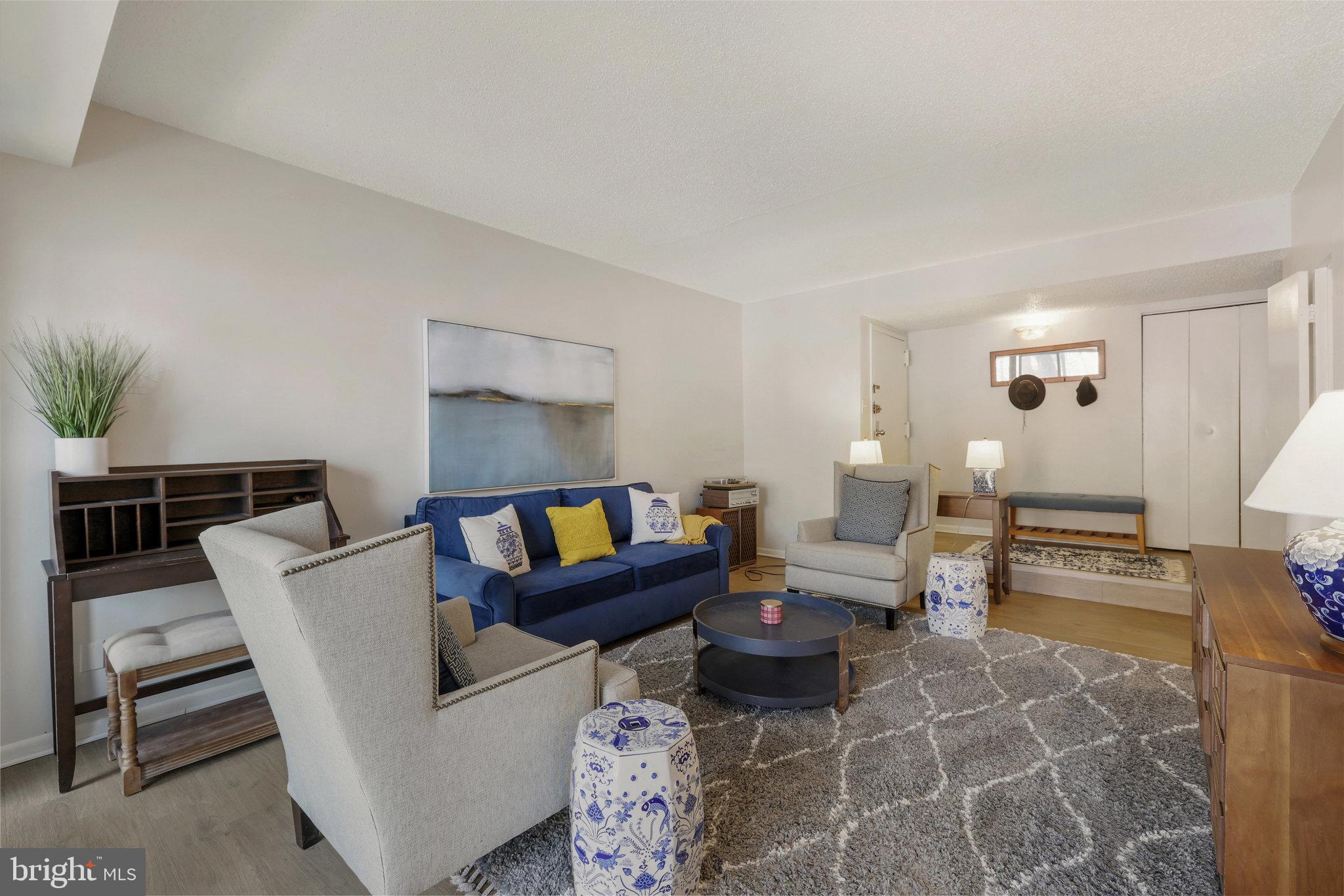 11812 Breton Court, Unit 1A Reston, VA 20191 - Photo 7 of 47 a living room with furniture a rug and a table
