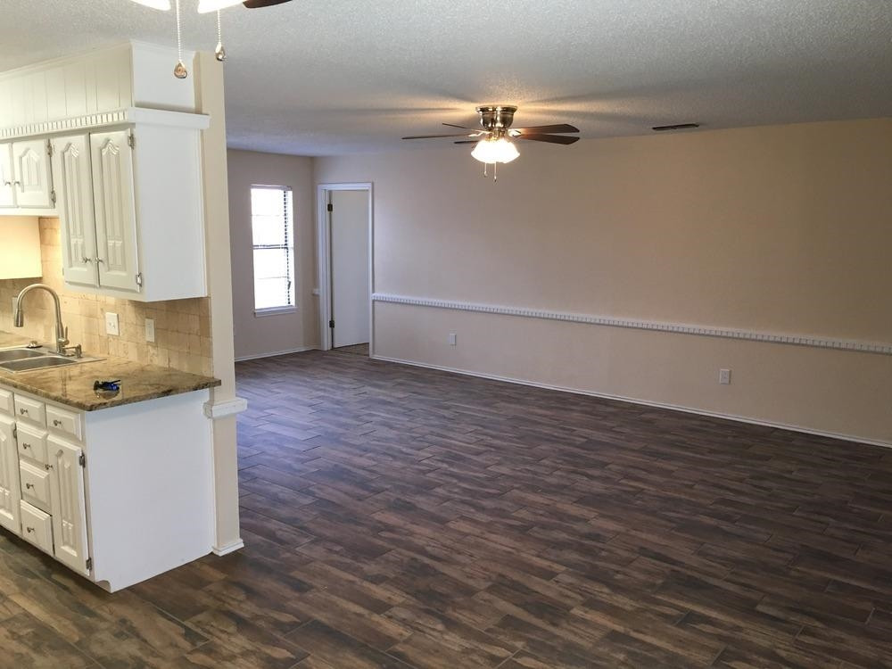 5739 Emory Street Lubbock, TX 79416 - Photo 3 of 10 a kitchen with stainless steel appliances granite countertop a sink stove and cabinets