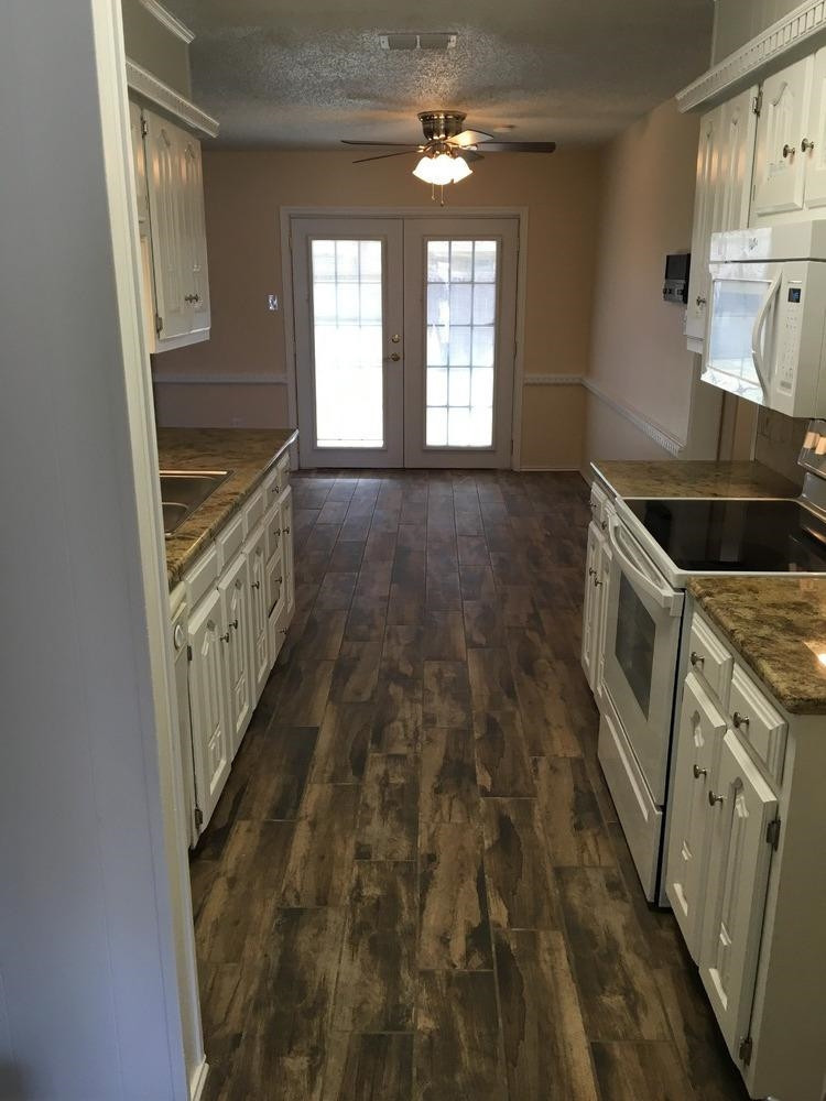 5739 Emory Street Lubbock, TX 79416 - Photo 10 of 10 a kitchen with granite countertop a stove and a sink
