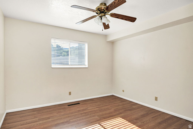 240 East 400 North, Unit 26 Logan, UT 84321 - Photo 7 of 12 Room with wood-finish flooring, a window with horizontal blinds, and a ceiling fan with light fixture