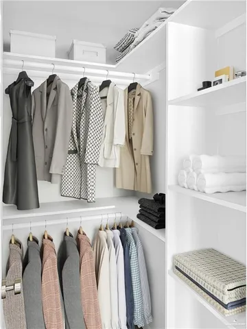 a view of walk in closet with clothes and shoes
