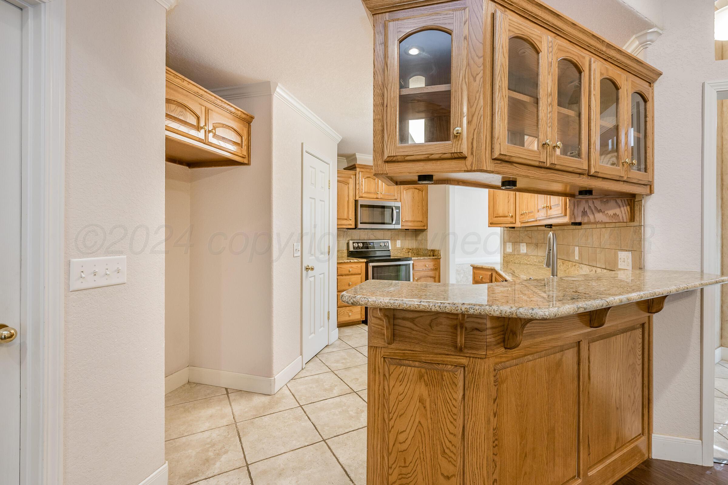6308 Academy Drive Amarillo, TX 79119 - Photo 8 of 21 a kitchen with stainless steel appliances granite countertop a refrigerator and a stove