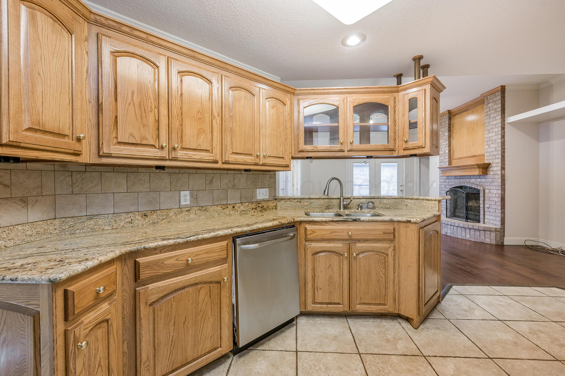 6308 Academy Drive Amarillo, TX 79119 - Photo 10 of 21 a kitchen with stainless steel appliances granite countertop a sink and cabinets