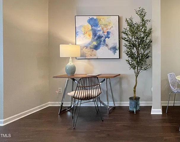 a view of a room with furniture and wooden floor