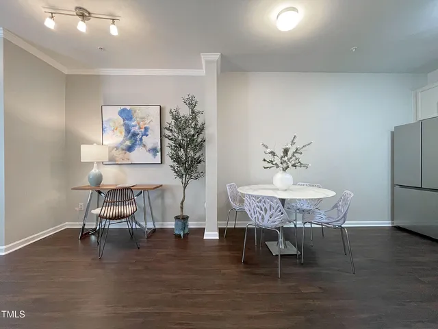 a dining room with furniture and wooden floor