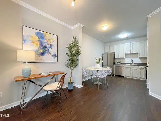 a living room with furniture and a painting on the wall