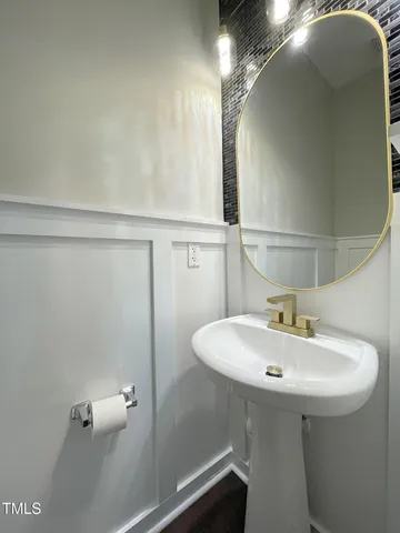 a bathroom with a sink a toilet and mirror