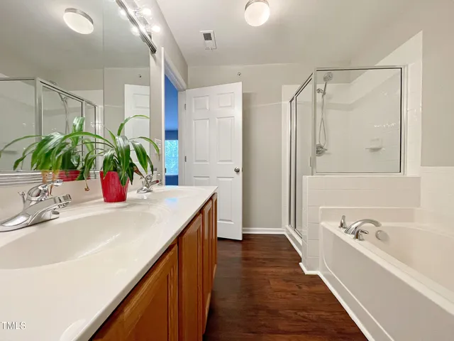 a bathroom with a sink a large mirror and a shower