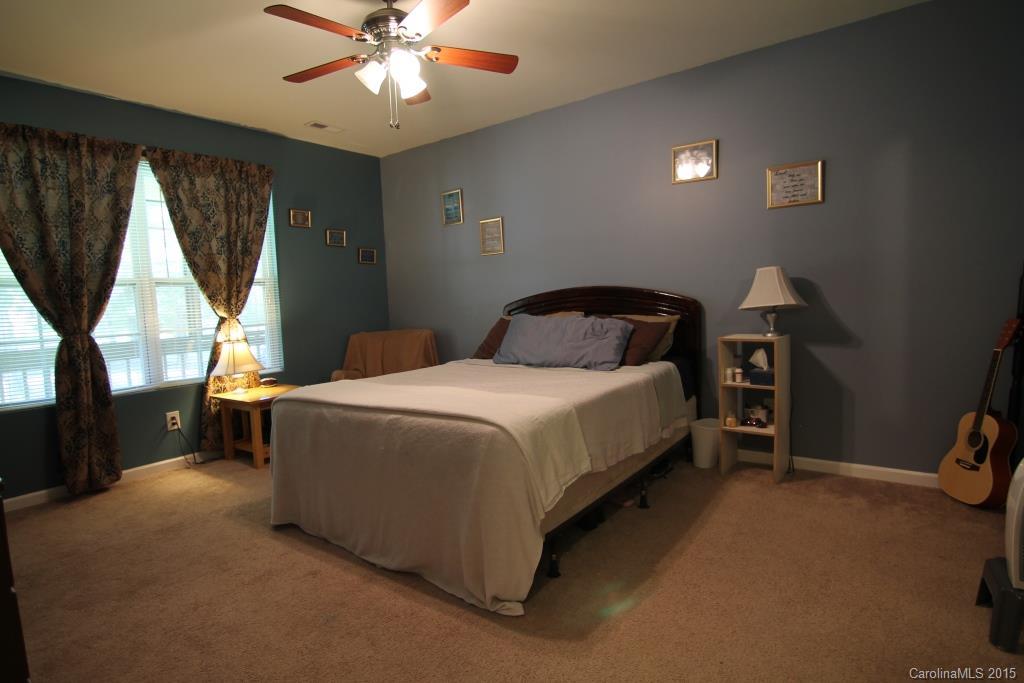 3807 White Store Road, Unit TRACT 1 W Wingate, NC 28174 - Photo 15 of 20 a bedroom with a bed and a chandelier