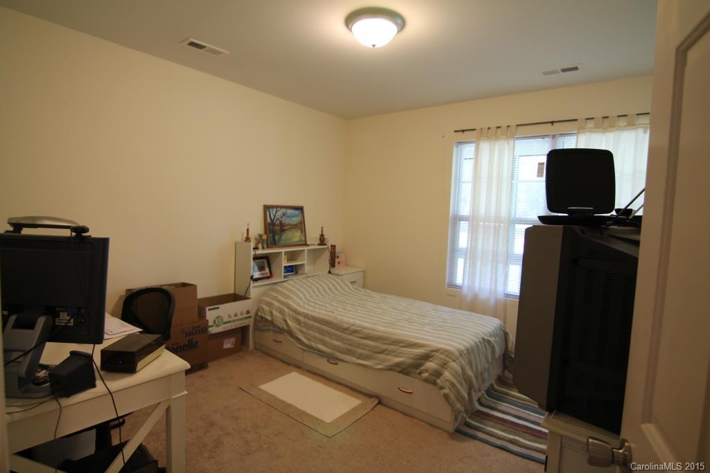 3807 White Store Road, Unit TRACT 1 W Wingate, NC 28174 - Photo 18 of 20 a bedroom with a bed and a computer on a desk next to a window